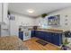 Inviting kitchen with white upper cabinets, blue lower cabinets and granite countertops at 324 Autumn Dr, Harrisburg, NC 28075