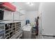 Spacious laundry room with shelving for storage, washer, dryer, and ample workspace at 324 Autumn Dr, Harrisburg, NC 28075