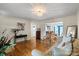 Open living area with hardwood floors flowing into the adjacent dining space at 324 Autumn Dr, Harrisburg, NC 28075