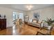 Comfortable living room with bright light and hardwood floors, adjacent to the dining area at 324 Autumn Dr, Harrisburg, NC 28075