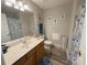 Bathroom featuring a vanity with sink, toilet, and shower with tasteful sea decor at 3300 Luke Ct, Monroe, NC 28112
