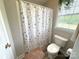 Charming bathroom featuring an Eiffel Tower shower curtain, toilet, and window at 3300 Luke Ct, Monroe, NC 28112