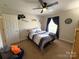 This bedroom features a ceiling fan and nice light from the window at 3300 Luke Ct, Monroe, NC 28112