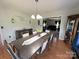 Open concept: Dining room with a long table flowing into the living room at 3300 Luke Ct, Monroe, NC 28112