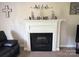 Close-up of a cozy fireplace with decorative accents and a neutral mantel at 3300 Luke Ct, Monroe, NC 28112