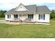 Inviting home with a charming front porch, American flag, and well-kept lawn at 3300 Luke Ct, Monroe, NC 28112