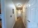Long, narrow hallway with multiple doors and a neutral color scheme at 3300 Luke Ct, Monroe, NC 28112