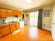 Traditional style kitchen with wood cabinets and a door leading to an outdoor patio at 3300 Luke Ct, Monroe, NC 28112
