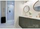 Stylish bathroom featuring double vanity with green cabinets and a walk-in shower at 3300 Travis Nw Ln, Concord, NC 28027