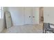 Clean bedroom featuring light wood floors, white walls, and a tall mirror at 3300 Travis Nw Ln, Concord, NC 28027