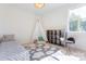 Cozy bedroom with a bed, teepee, cloud rug, and ample natural light from a window at 3300 Travis Nw Ln, Concord, NC 28027