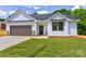 Charming one-story home featuring white siding, a brown garage door, and a well-manicured lawn at 3300 Travis Nw Ln, Concord, NC 28027