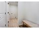 Hallway with a bench, light wood floors, and doors leading to other rooms at 3300 Travis Nw Ln, Concord, NC 28027