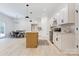 Modern kitchen featuring white cabinets, a wood-tone island, and adjacent dining area at 3300 Travis Nw Ln, Concord, NC 28027