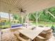 Covered patio with a swing and seating with view of a brick fireplace at 3610 Mill Pond Rd, Charlotte, NC 28226
