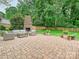 Outdoor patio with seating area and a brick fireplace at 3610 Mill Pond Rd, Charlotte, NC 28226