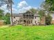 Expansive backyard featuring a screened porch, patio, brick fireplace, and lush green lawn at 3610 Mill Pond Rd, Charlotte, NC 28226
