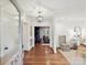 Bright foyer showcasing hardwood floors, elegant lighting, and seamless flow to the living spaces at 3610 Mill Pond Rd, Charlotte, NC 28226