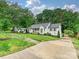 Charming home with manicured lawn, inviting curb appeal, and private driveway at 3610 Mill Pond Rd, Charlotte, NC 28226