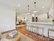 Bright, open kitchen featuring a breakfast bar with seating, pendant lighting, and hardwood floors at 3610 Mill Pond Rd, Charlotte, NC 28226