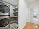 Modern laundry room with a stackable washer/dryer and custom shelving at 3610 Mill Pond Rd, Charlotte, NC 28226