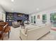 Inviting living room with a brick fireplace, built-in shelving, and access to the outdoor patio at 3610 Mill Pond Rd, Charlotte, NC 28226
