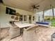 Outdoor patio with a ceiling fan, seating, and a swing at 3610 Mill Pond Rd, Charlotte, NC 28226