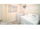 Well-lit laundry room with a washer, dryer, and shelving for storage, plus decorative laundry-themed wall art at 3868 Maxwell Henry Nw Ln, Conover, NC 28613