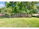 Spacious backyard featuring mature trees, a well-maintained lawn, and a charming wooden fence at 415 Princeton Dr, Salisbury, NC 28144