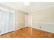 Empty bedroom with hardwood floors, white trim, double closets, and neutral walls at 415 Princeton Dr, Salisbury, NC 28144