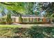 Charming brick home featuring green shutters, mature trees, and a well-maintained lawn at 415 Princeton Dr, Salisbury, NC 28144