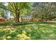 Beautifully landscaped front yard with lush greenery and mature trees providing ample shade at 415 Princeton Dr, Salisbury, NC 28144