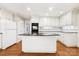 Bright kitchen with white cabinetry, granite counters, and island with sleek appliances at 415 Princeton Dr, Salisbury, NC 28144