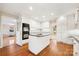 A bright kitchen with an island, double oven, white cabinets, and hardwood floors at 415 Princeton Dr, Salisbury, NC 28144