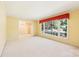 Spacious living room featuring neutral carpet, light yellow walls, and a large window at 415 Princeton Dr, Salisbury, NC 28144