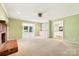 Spacious carpeted living room with a brick fireplace and view to another living space at 415 Princeton Dr, Salisbury, NC 28144