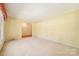 Bright living room with light carpet, yellow walls, and an open doorway at 415 Princeton Dr, Salisbury, NC 28144