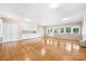 Expansive living room featuring hardwood floors, built-in storage, and plentiful windows at 415 Princeton Dr, Salisbury, NC 28144
