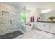 Bright bathroom with a luxurious soaking tub, separate glass shower, and elegant marble tile at 424 Preston Rd, Mooresville, NC 28117