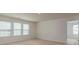 Sunlit bedroom featuring neutral paint, plush carpeting, and bright windows at 424 Preston Rd, Mooresville, NC 28117