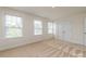 Bright bedroom featuring plush carpeting, windows, and closet at 424 Preston Rd, Mooresville, NC 28117