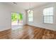 Dining room with hardwood floors, large windows, and a sliding glass door leading to the outdoor deck at 424 Preston Rd, Mooresville, NC 28117