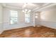 Dining room featuring wainscoting, hardwood floors and contemporary chandelier at 424 Preston Rd, Mooresville, NC 28117