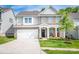 Beautiful two-story home showcasing a well-manicured lawn, brick accents, and a welcoming front porch with rocking chairs at 424 Preston Rd, Mooresville, NC 28117