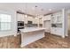 Modern kitchen with white cabinets, stainless steel appliances, a large center island, and hardwood floors at 424 Preston Rd, Mooresville, NC 28117