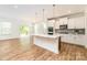 Open kitchen featuring a large island with quartz countertops and stainless steel appliances at 424 Preston Rd, Mooresville, NC 28117