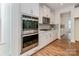 Kitchen featuring stainless steel appliances, white cabinets, and hardwood floors at 424 Preston Rd, Mooresville, NC 28117