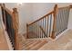 Classic staircase featuring wood railing and carpeted steps at 424 Preston Rd, Mooresville, NC 28117