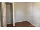 Spare bedroom with laminate flooring and open closet, ready for personalization and furnishing at 4630 Roberta Rd, Concord, NC 28027