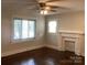 Bright bedroom with hardwood floors, natural light, and classic architectural details like a vintage fireplace at 4630 Roberta Rd, Concord, NC 28027